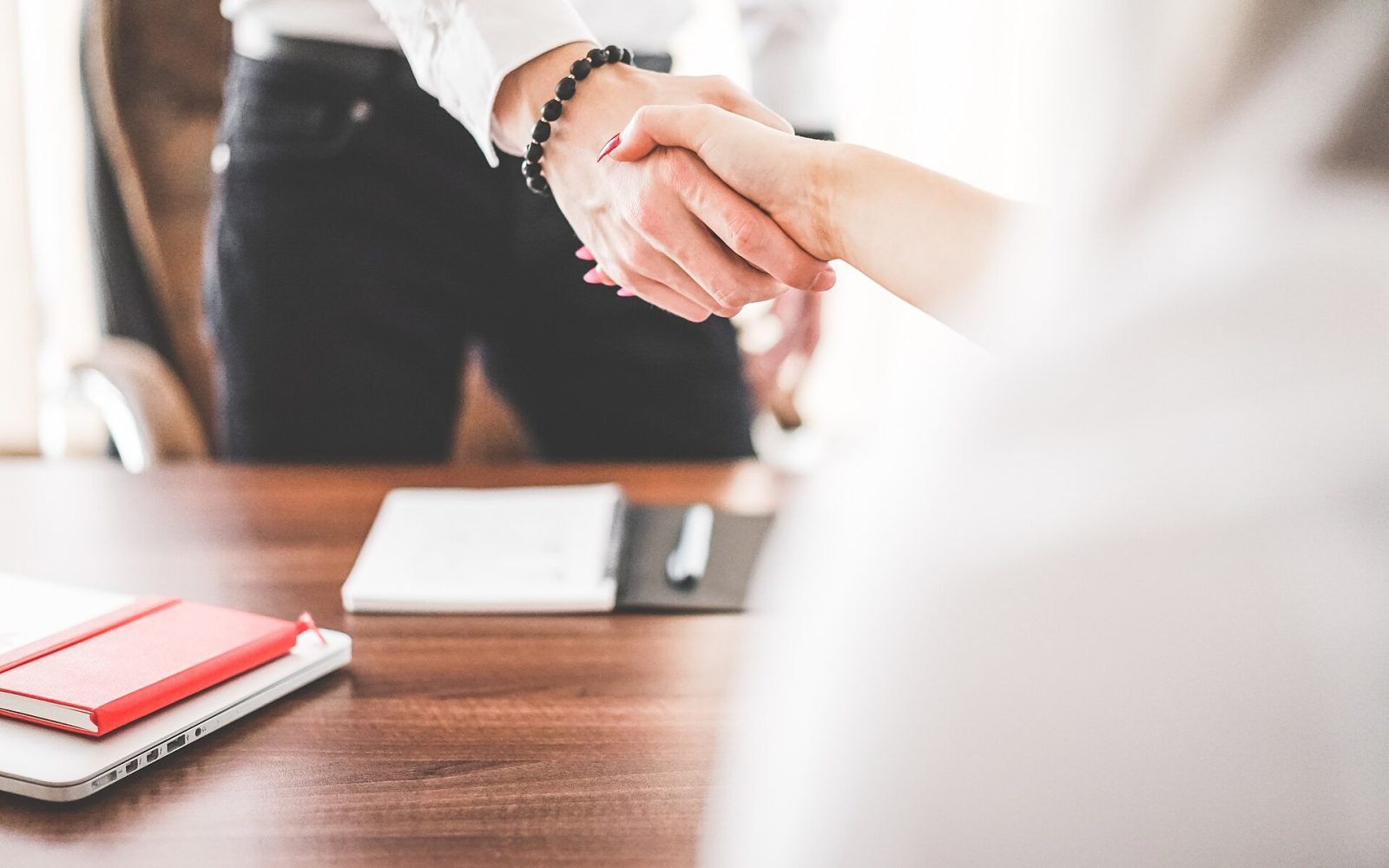 Business man and woman handshake in work office