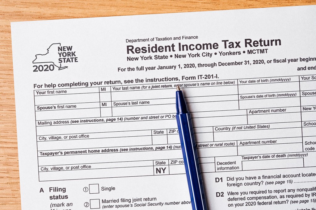 A ballpoint pen resting on a printed income tax return form