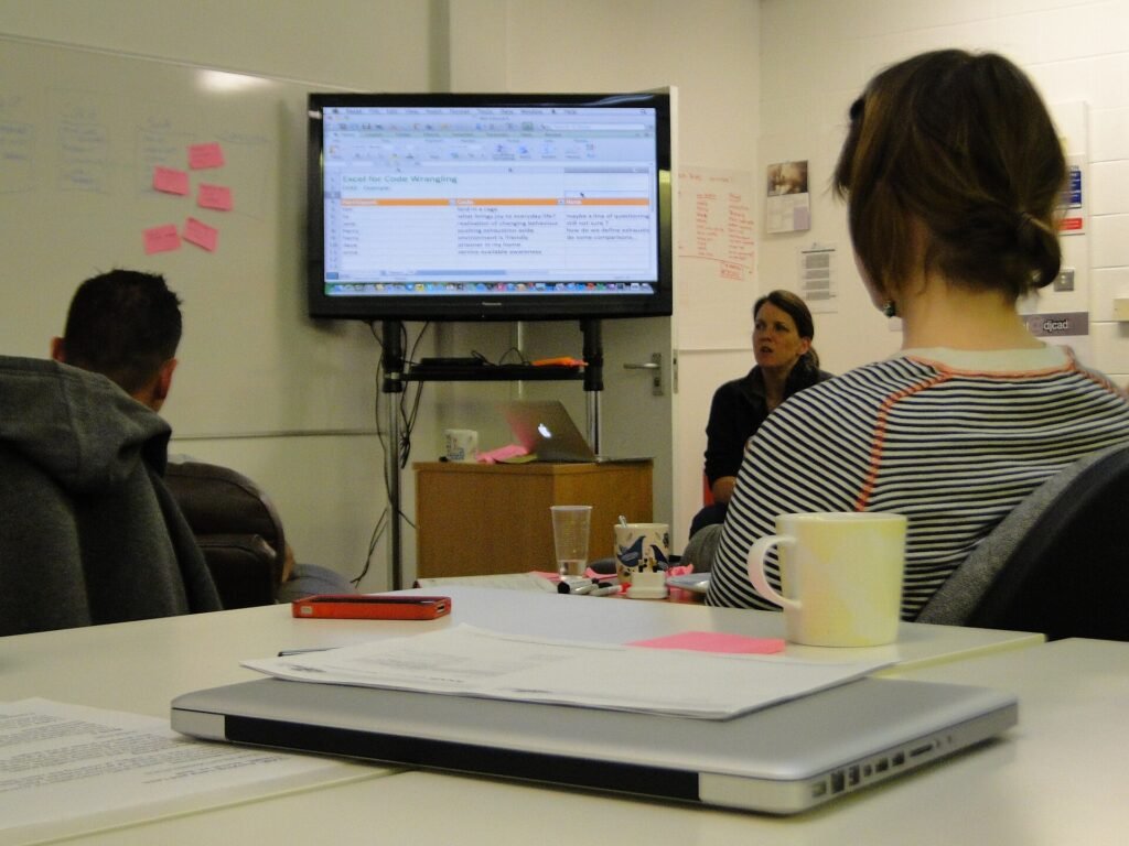 A group of people reviewing data together on a large screen