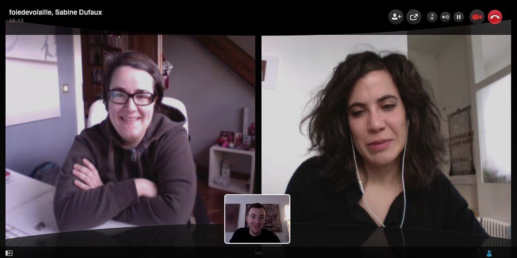 A laptop screen showing a video conference call