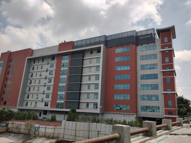 A multi-storey office building at Bagmane Tech Park in Bengaluru under a cloudy sky