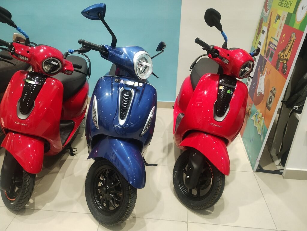 A row of Bajaj Chetak electric scooters displayed at a store in Bengaluru