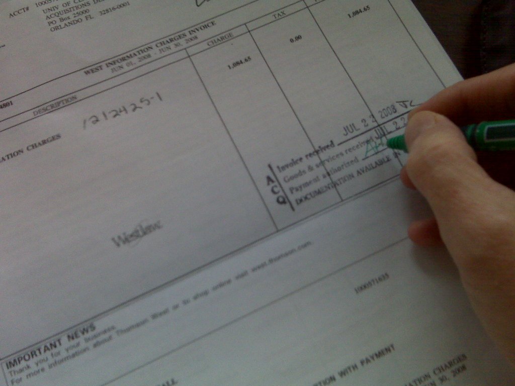 A stack of paper invoices on a desk