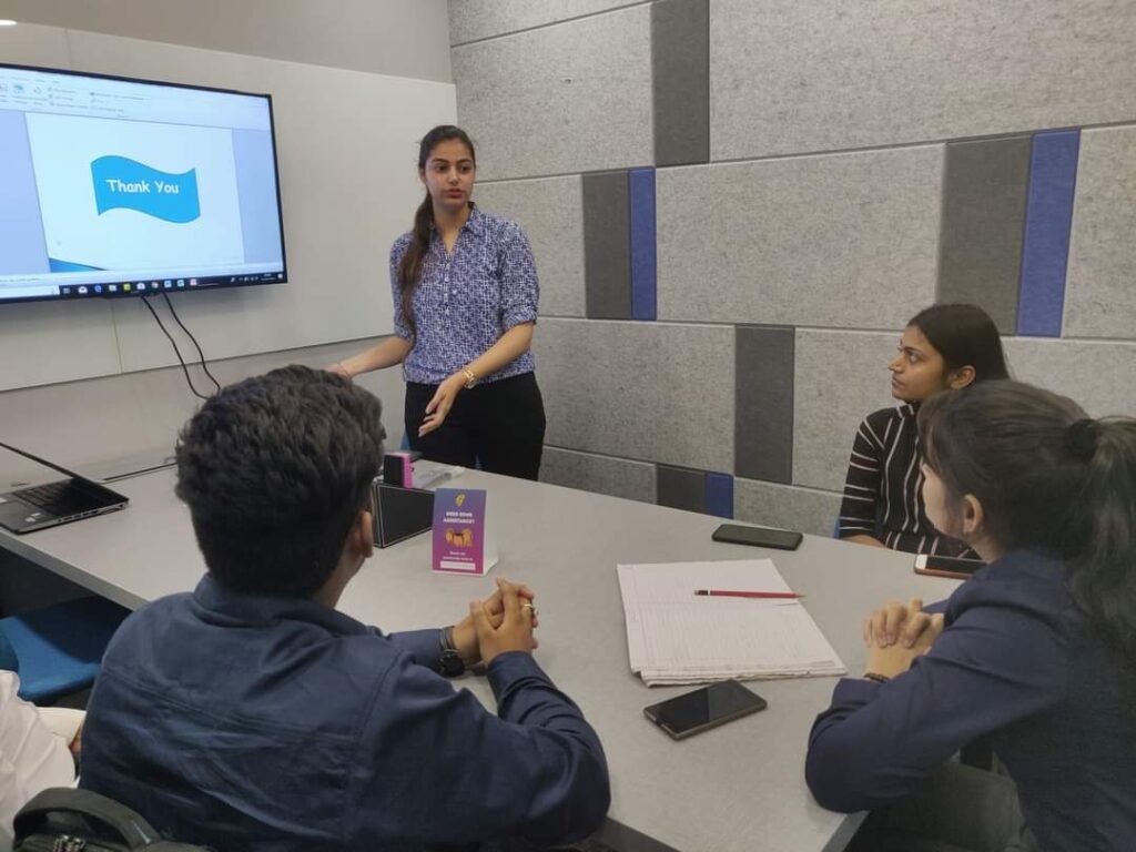 A startup team gathered around a screen during a presentation