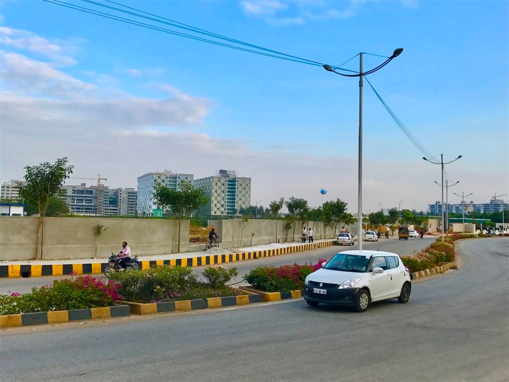 A tree-lined road running through a business park in Bengaluru