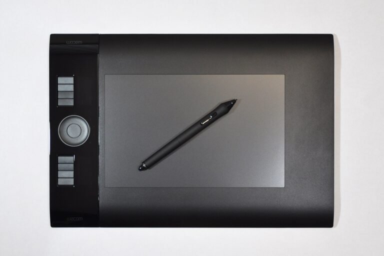 A Wacom Intuos4 pen tablet with its stylus on a desk