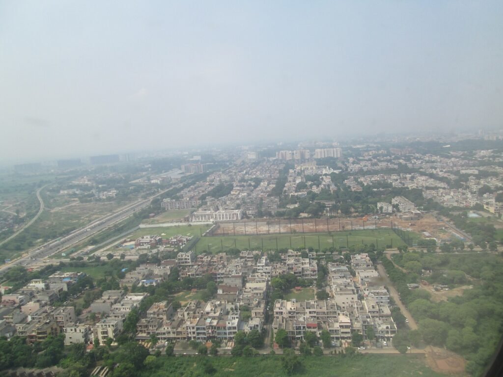 Aerial view of Chandigarh with tree-lined streets and low-rise buildings