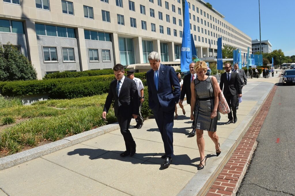 Airbnb CEO Brian Chesky walking alongside then US Secretary of State John Kerry in Washington, DC, in 2016