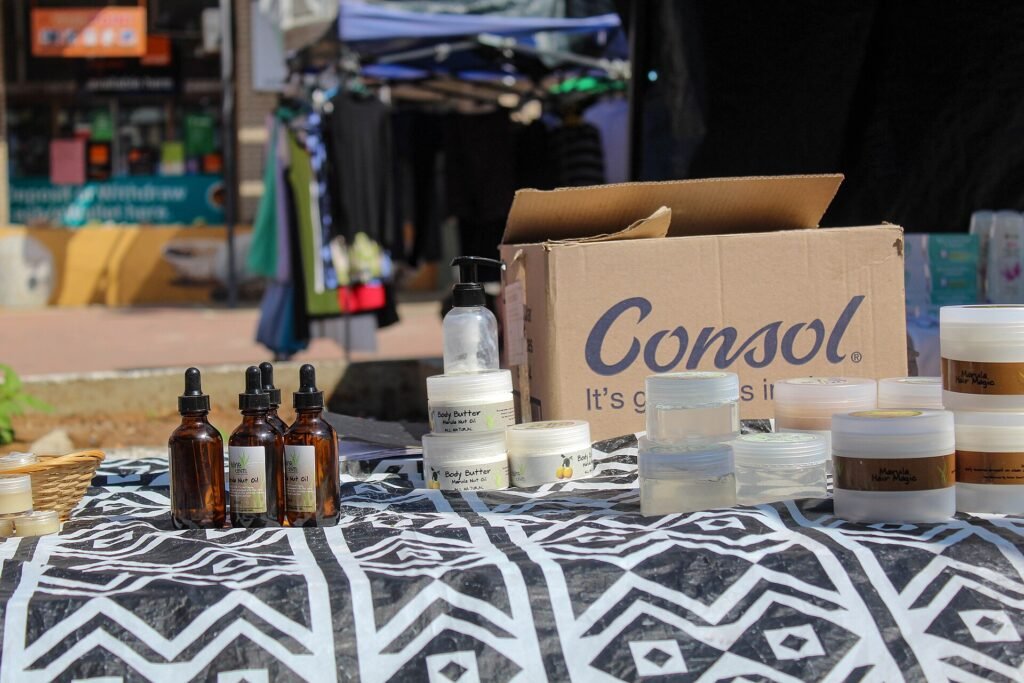 Amber dropper bottles and jars of skin care products displayed on a patterned cloth