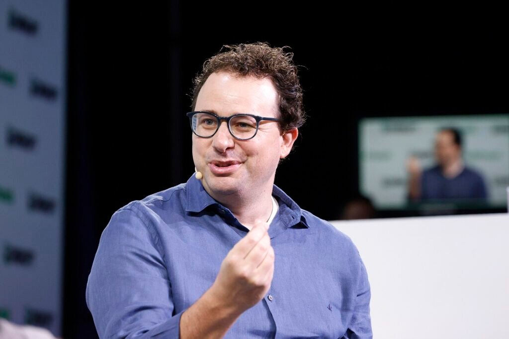 Anthropic CEO Dario Amodei speaking on stage at TechCrunch Disrupt 2023