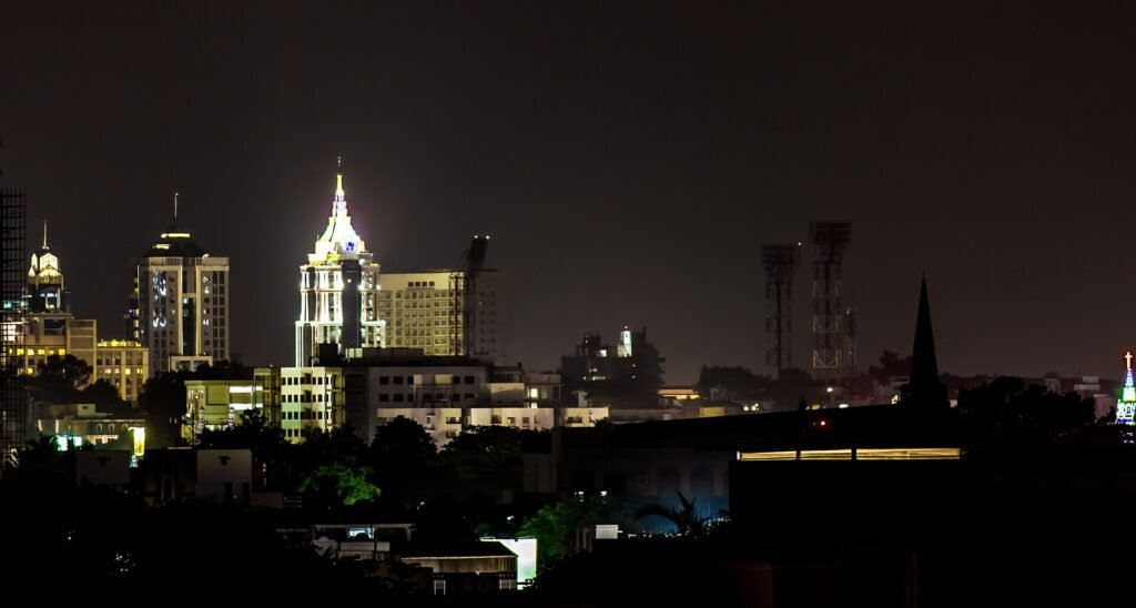 Bengaluru city skyline with high-rise buildings under a hazy sky