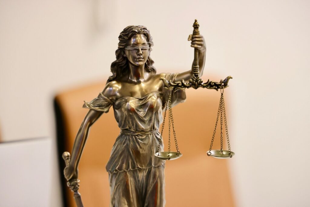 Close-up of a Lady Justice statue holding scales at a civil court building in Melbourne