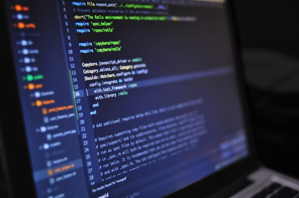 Close-up of a laptop screen showing lines of code in a dark-themed editor