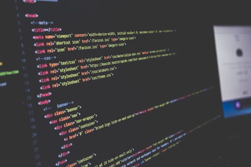 Close-up of a monitor showing colour-highlighted HTML code