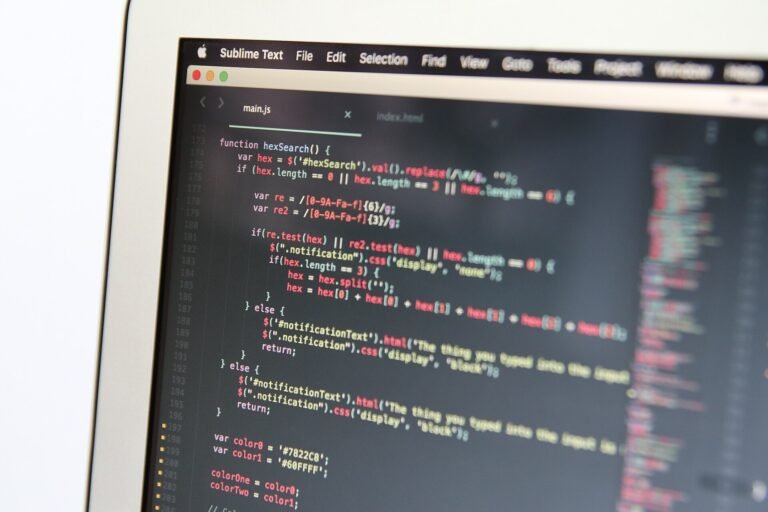 Close-up of colourful lines of code in a text editor on a laptop screen