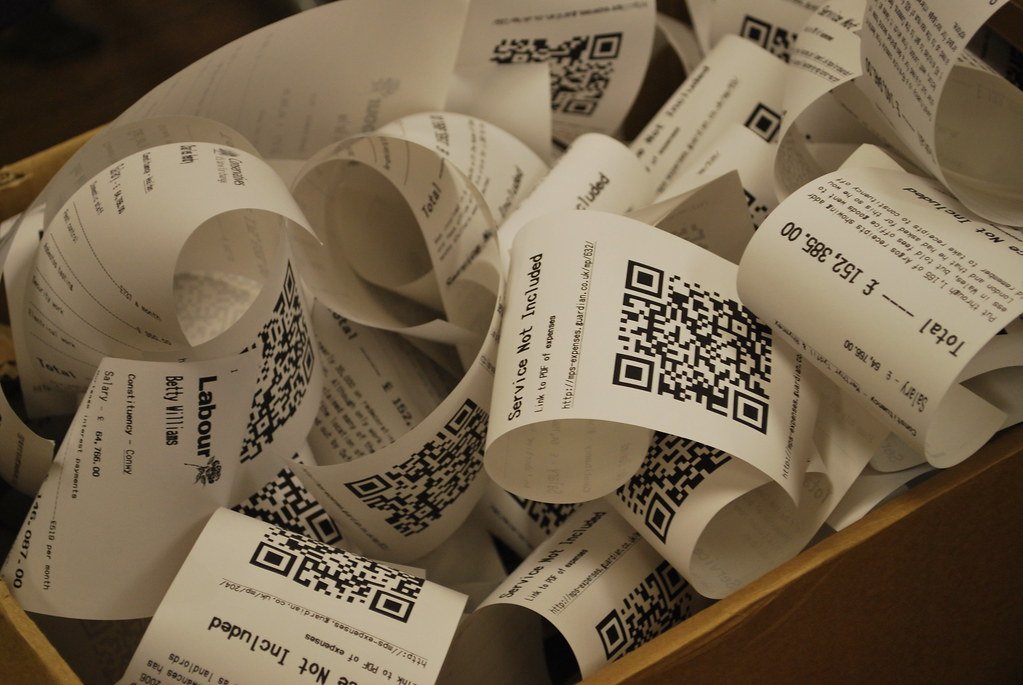 Close-up of paper receipts spooling out of a printer