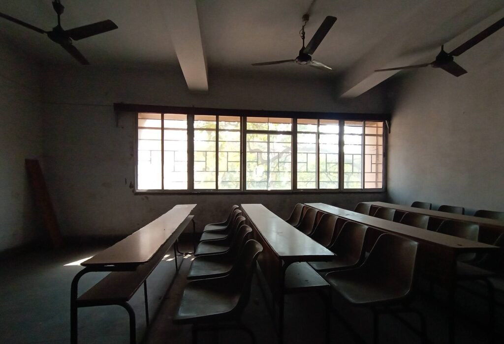 Empty classroom with wooden benches at the University of Calcutta