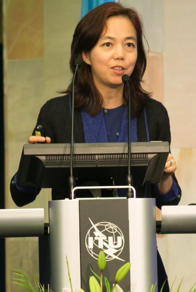 Fei-Fei Li speaking on stage at the AI for Good summit in 2017
