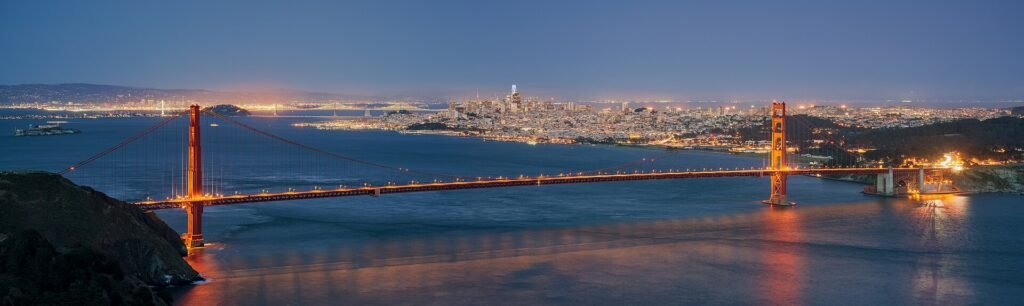 Golden Gate Bridge and the San Francisco skyline at dusk seen from Hawk Hill
