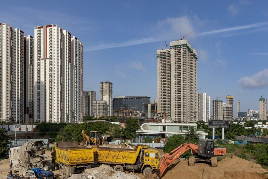 High-rise towers in Hyderabad's Financial District with construction machinery in the foreground