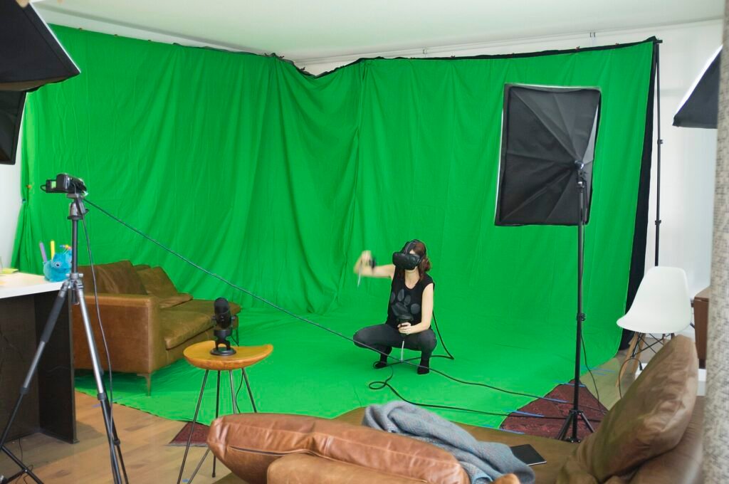 Home video studio with a green screen backdrop, lights and a camera