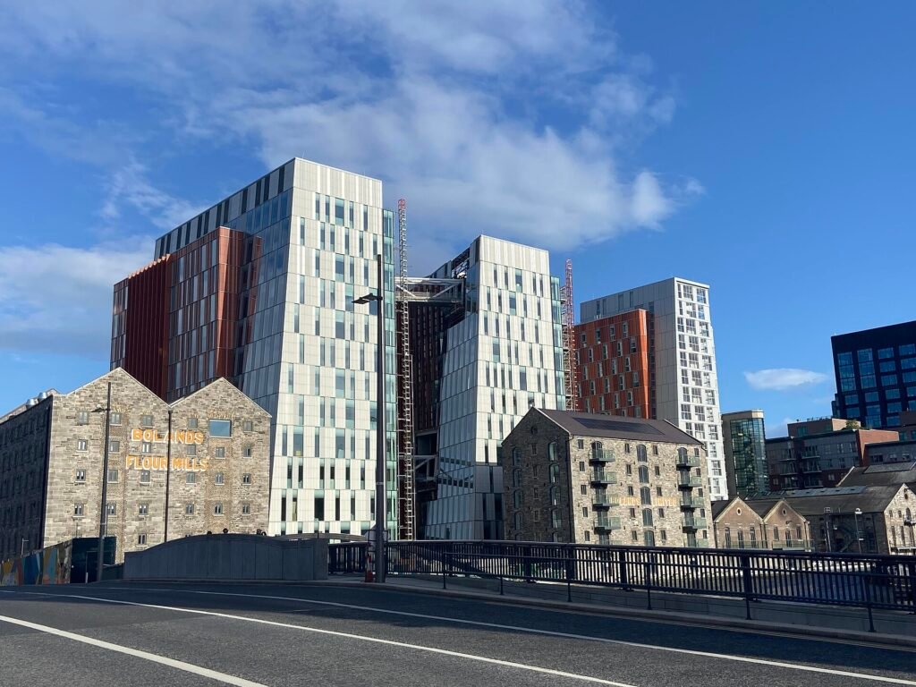 Modern office towers behind old stone warehouse buildings at Bolands Quay in Dublin’s Docklands