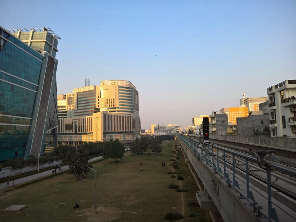 Office buildings at DLF Cyber City in Gurugram beside the Rapid Metro line at dusk