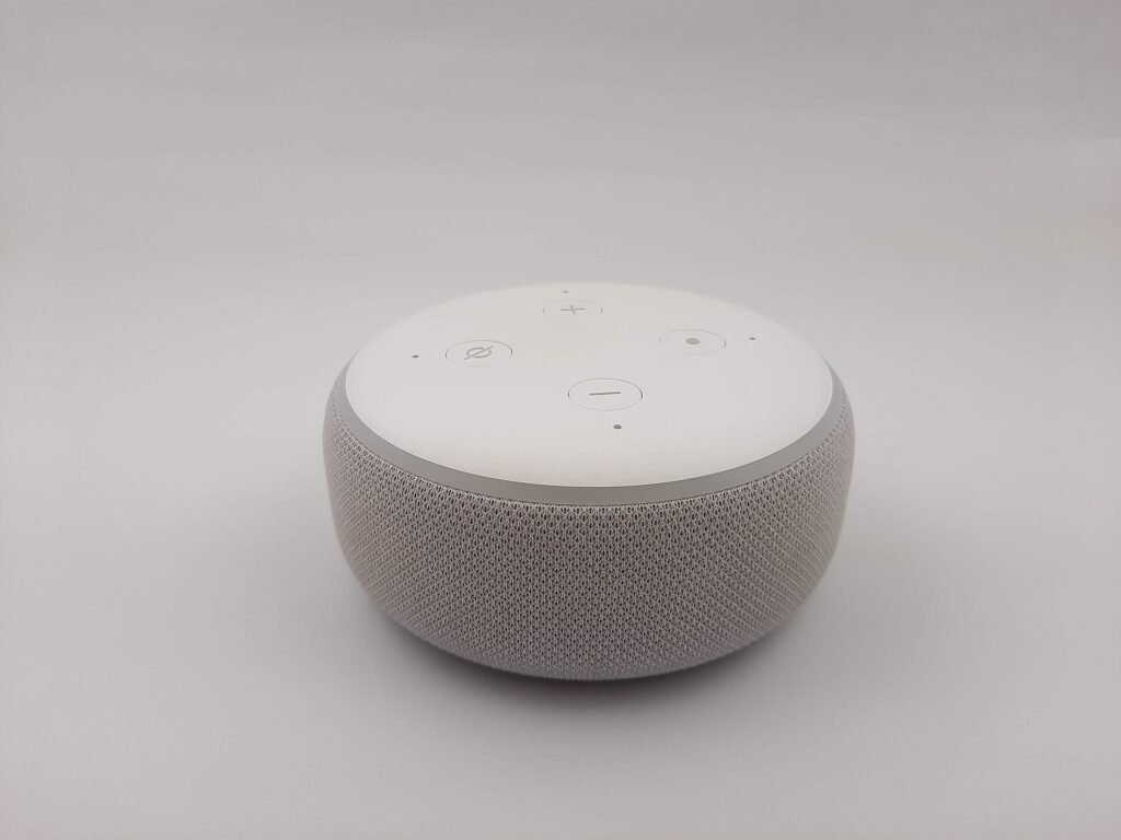 Round fabric-covered smart speaker on a table