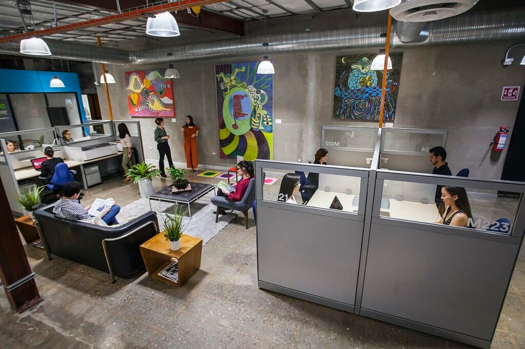 Rows of empty office desks and cubicles in an open-plan business centre