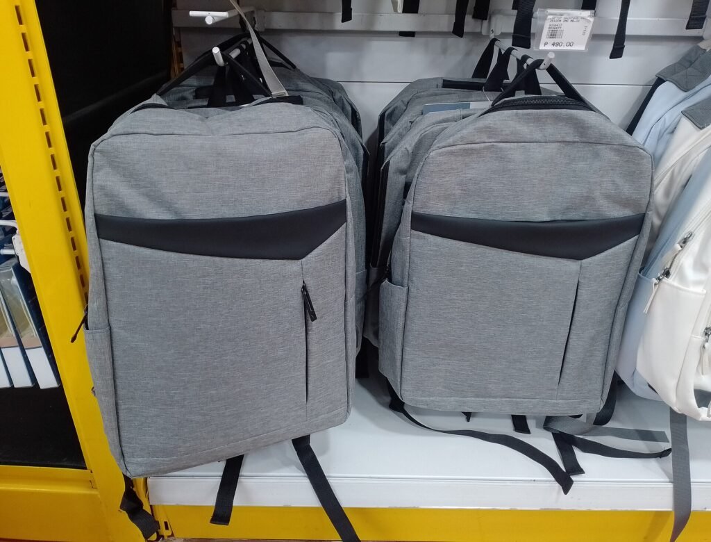 Rows of laptop backpacks hanging on a retail store wall