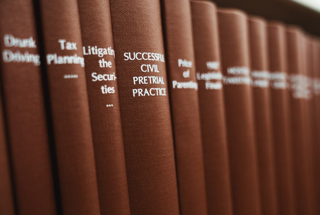 Rows of litigation and civil trial practice law books on a library shelf