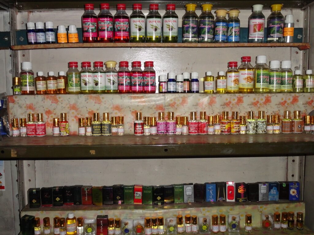 Rows of perfume bottles on display shelves in a shop in Ooty, India