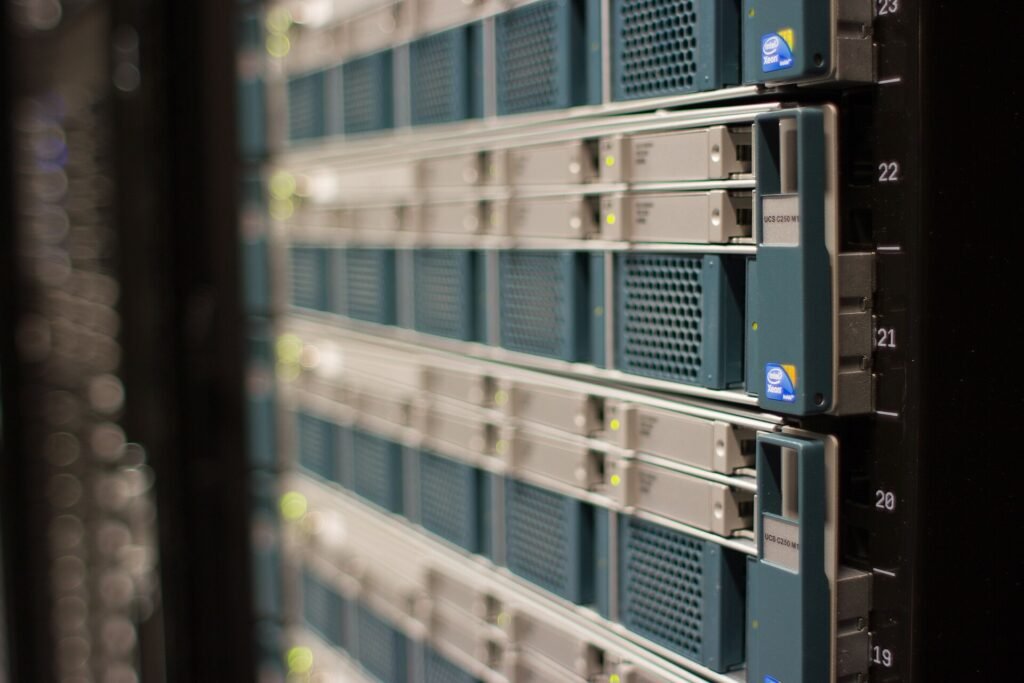 Rows of rack-mounted servers with blinking lights in a data centre
