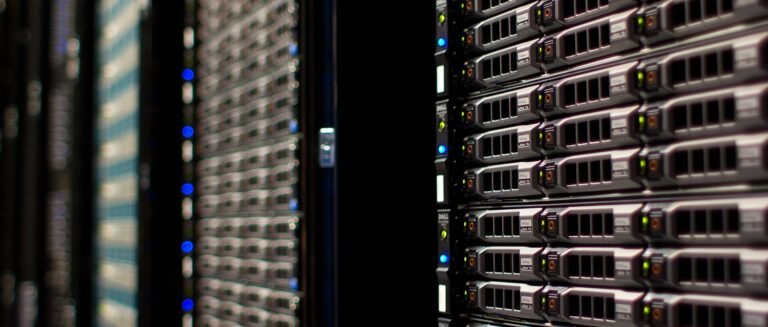 Rows of server racks with blinking lights inside a data centre