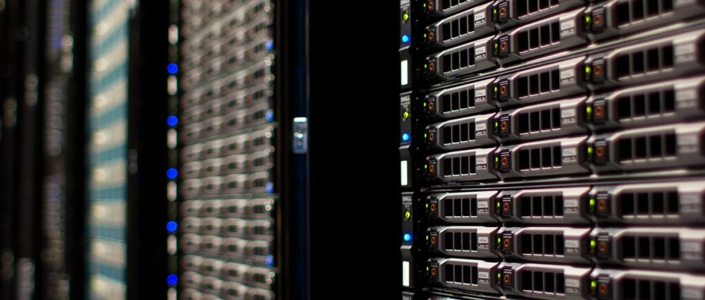 Rows of server racks with network cables in a data centre