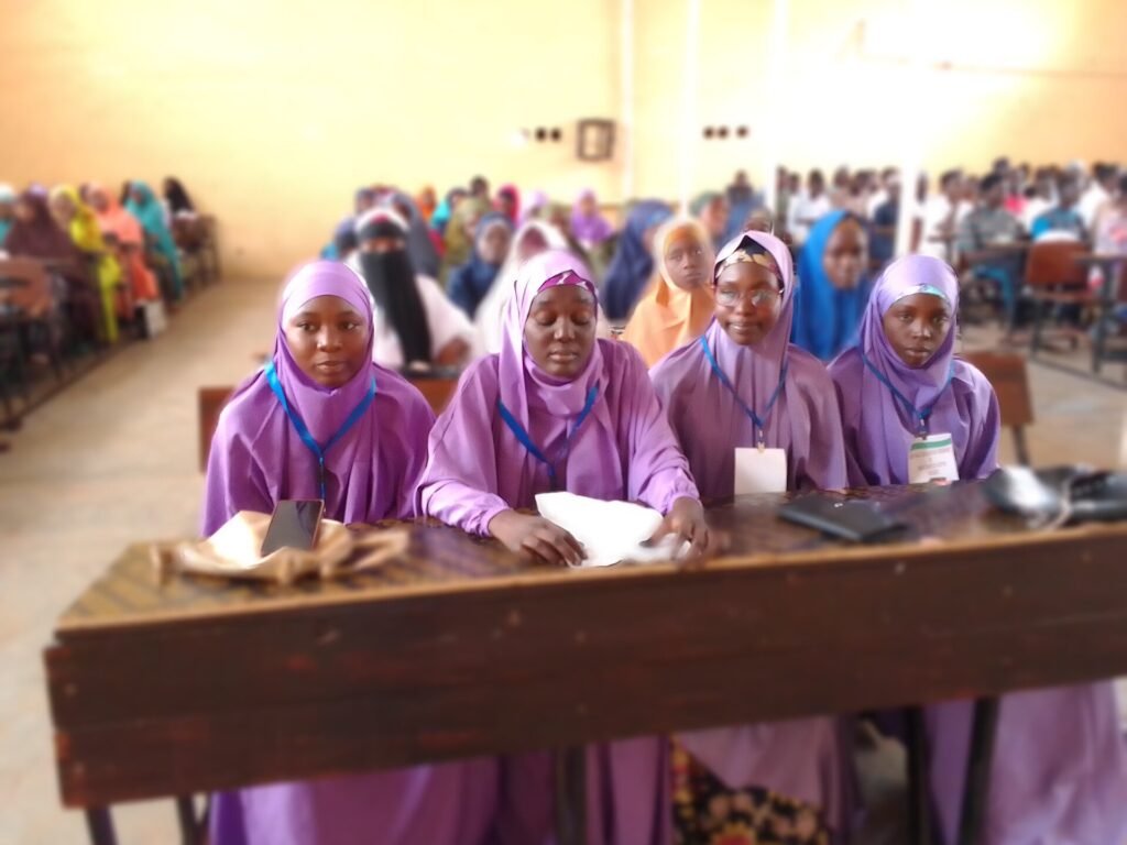 Students seated in rows in a university lecture hall