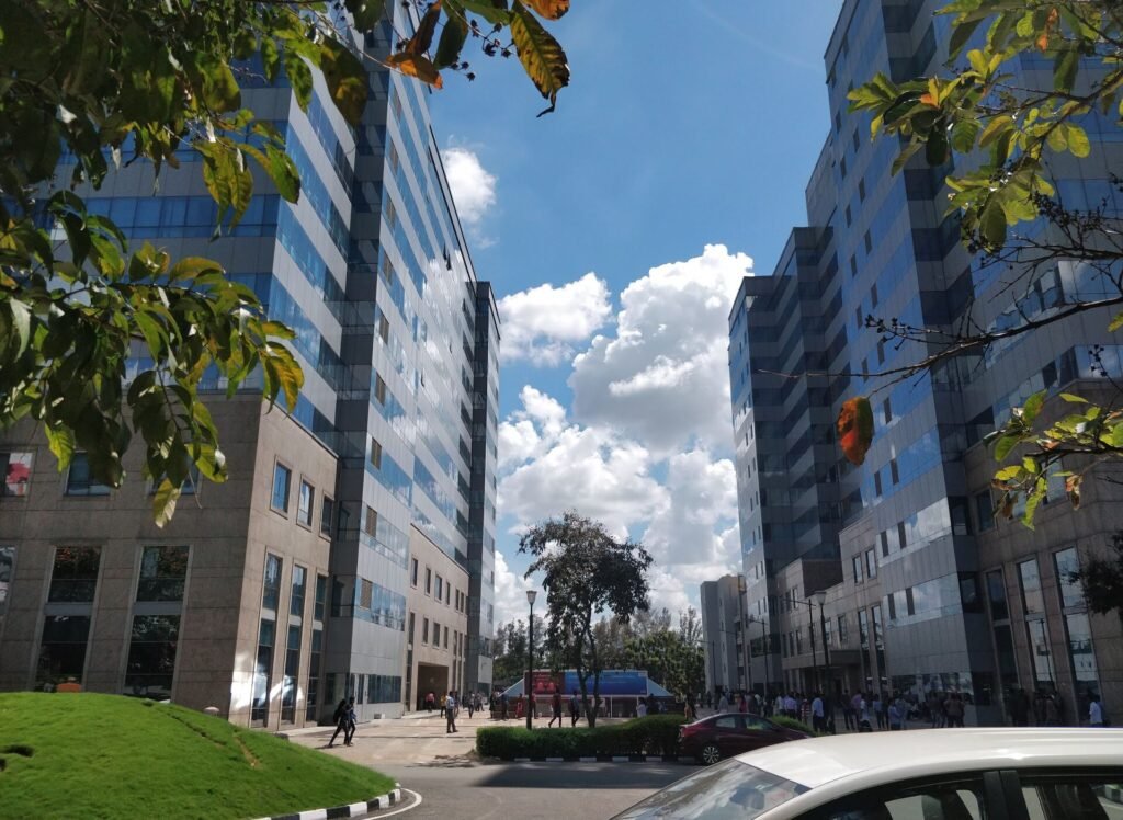 Tall glass office buildings at International Tech Park in Whitefield, Bengaluru, under a blue sky