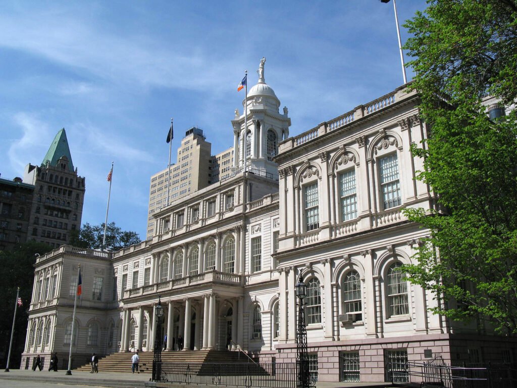 The front of New York City Hall with its columns and clock tower