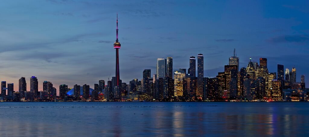 Toronto skyline with the CN Tower at sunset, seen across the water from Snake Island