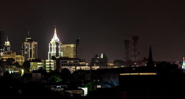 Wide view of the Bengaluru skyline with high-rise buildings and trees